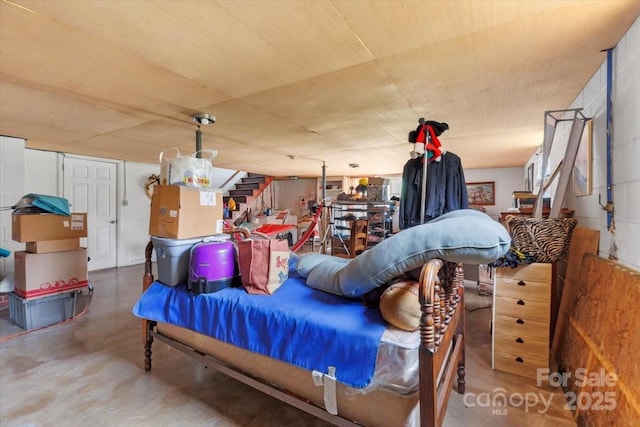 bedroom featuring concrete floors