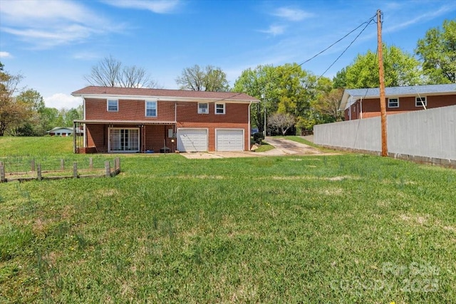 back of property featuring a garage and driveway