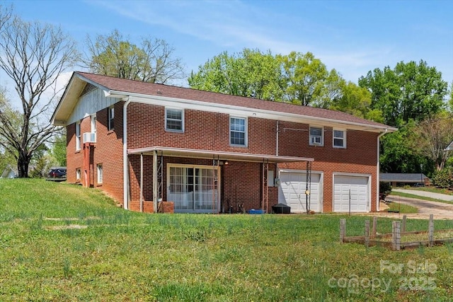 view of front of home featuring an attached garage, brick siding, a front lawn, driveway, and cooling unit