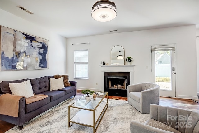5713 Falkirk Ln, Matthews, NC 28104 - living area with wood finished floors and a fireplace with flush hearth