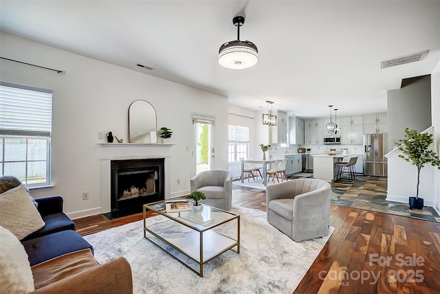 5713 Falkirk Ln, Matthews, NC 28104 - living room with a fireplace with raised hearth and dark wood-style flooring