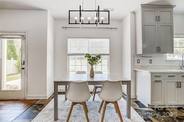 5713 Falkirk Ln, Matthews, NC 28104 - dining room featuring plenty of natural light, a chandelier, and light wood-type flooring