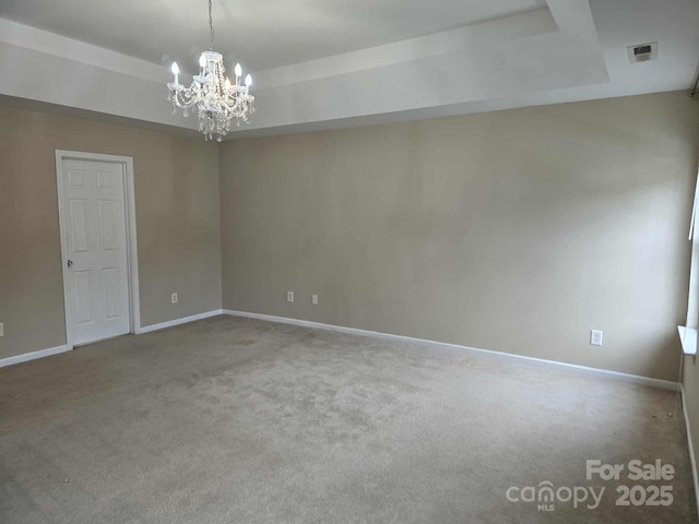5713 Falkirk Ln, Matthews, NC 28104 - empty room featuring a raised ceiling, a chandelier, and carpet