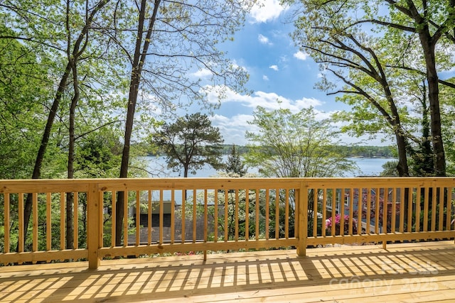 wooden deck featuring a water view