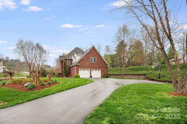 201 Springwood Dr NE, Valdese, NC 28690 - view of home's exterior with a lawn, driveway, brick siding, an attached garage, and fence