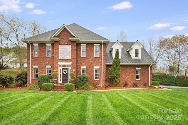 201 Springwood Dr NE, Valdese, NC 28690 - view of front of house with a shingled roof, brick siding, and a front yard