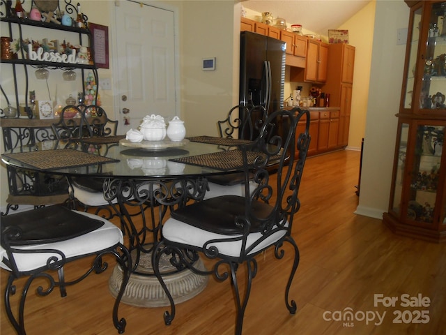 dining space featuring light wood-style flooring