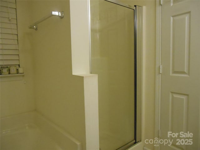 bathroom with a stall shower and a tub to relax in