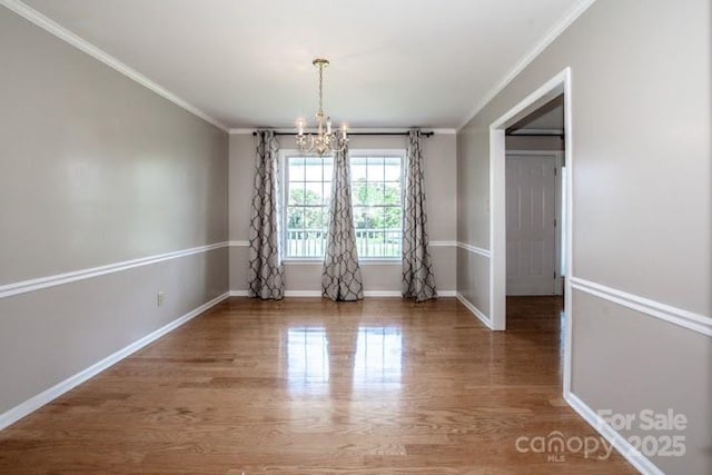 2811 Saint James Church Rd, Denver, NC 28037 - unfurnished dining area with a chandelier, ornamental molding, wood finished floors, and baseboards