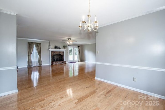 2811 Saint James Church Rd, Denver, NC 28037 - unfurnished living room with a chandelier, wood finished floors, a ceiling fan, a fireplace, and ornamental molding