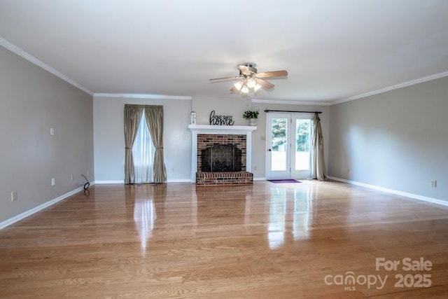2811 Saint James Church Rd, Denver, NC 28037 - unfurnished living room featuring a ceiling fan, baseboards, a brick fireplace, wood finished floors, and crown molding