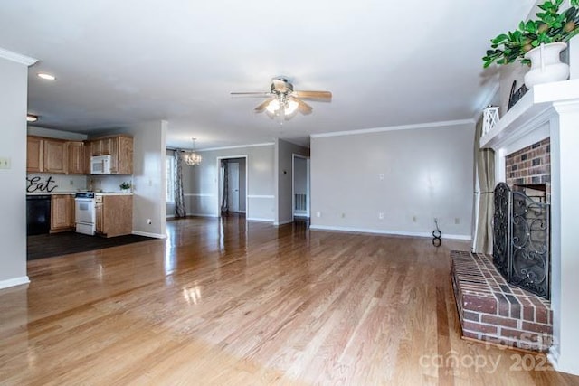 2811 Saint James Church Rd, Denver, NC 28037 - unfurnished living room featuring ceiling fan, a fireplace, a chandelier, baseboards, and ornamental molding