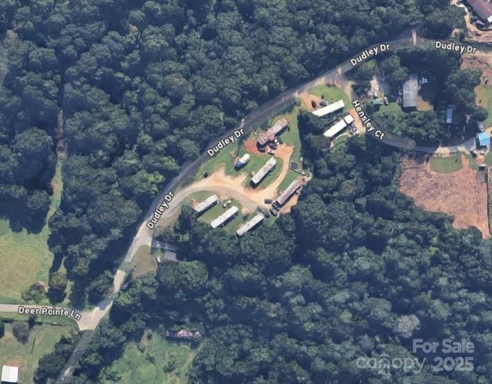 bird's eye view with a wooded view