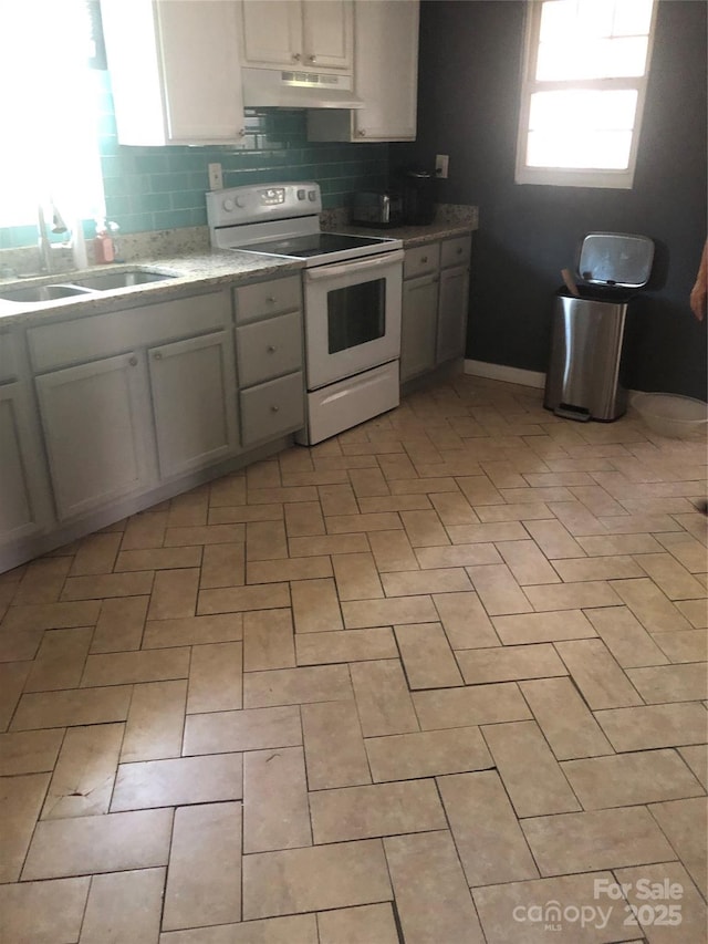 401 Plymouth St, Kannapolis, NC 28083 - kitchen with under cabinet range hood, white range with electric stovetop, light countertops, a sink, and backsplash