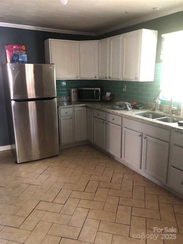 401 Plymouth St, Kannapolis, NC 28083 - kitchen featuring a sink, ornamental molding, tasteful backsplash, and stainless steel appliances