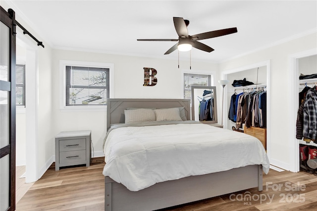 403 Greenbriar Rd S, Statesville, NC 28625 - bedroom featuring crown molding, light wood finished floors, baseboards, and a barn door