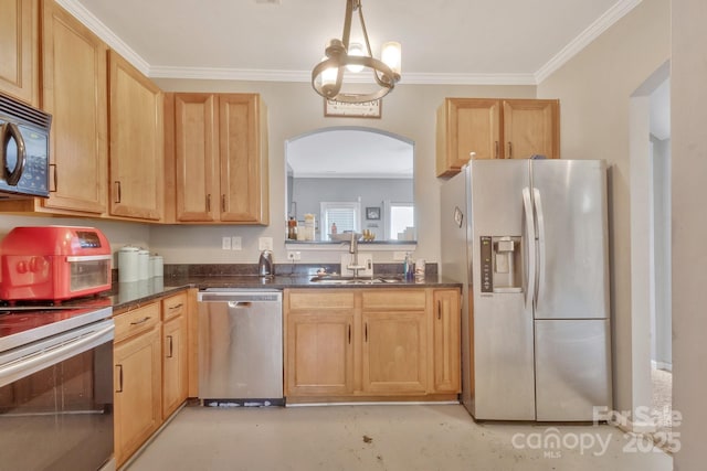 kitchen with light brown cabinetry, arched walkways, appliances with stainless steel finishes, and a sink