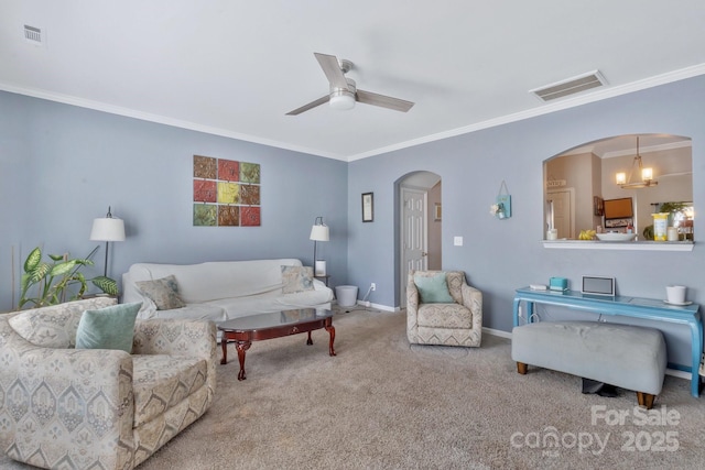 carpeted living area with arched walkways, ceiling fan, baseboards, and visible vents