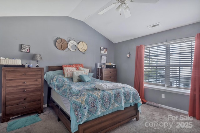 carpeted bedroom featuring a ceiling fan, baseboards, vaulted ceiling, and visible vents