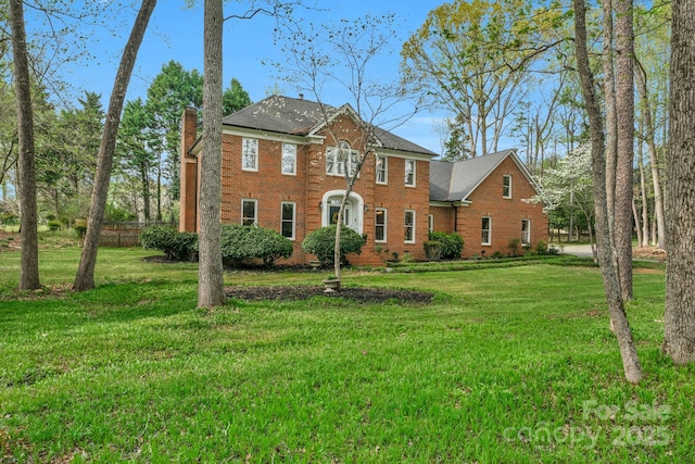 5750 Hemby Rd, Matthews, NC 28104 - colonial-style house featuring brick siding, a chimney, and a front lawn