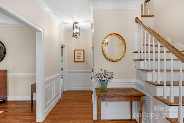 5750 Hemby Rd, Matthews, NC 28104 - hallway with ornamental molding, wood finished floors, stairway, and a wainscoted wall