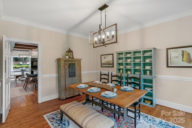 5750 Hemby Rd, Matthews, NC 28104 - dining area featuring baseboards, a notable chandelier, ornamental molding, and wood finished floors