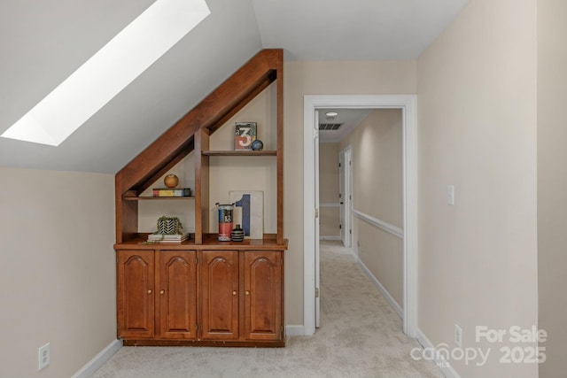5750 Hemby Rd, Matthews, NC 28104 - hall with baseboards, visible vents, lofted ceiling with skylight, and light colored carpet