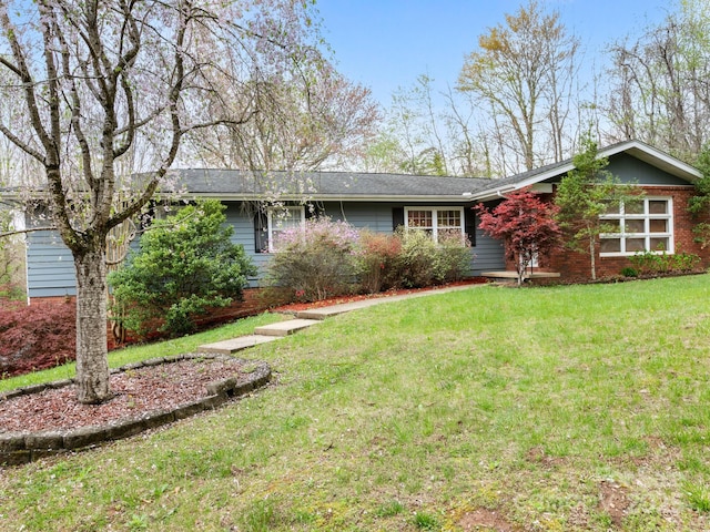 ranch-style home featuring a front yard