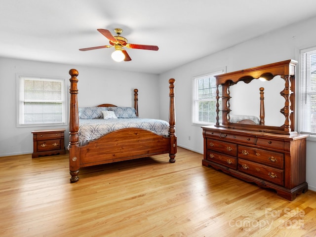 bedroom featuring light wood-style floors, ceiling fan, and baseboards