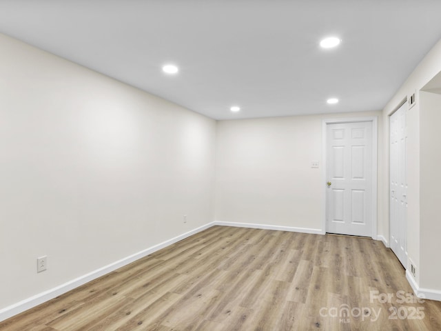 finished basement featuring light wood-type flooring, baseboards, visible vents, and recessed lighting
