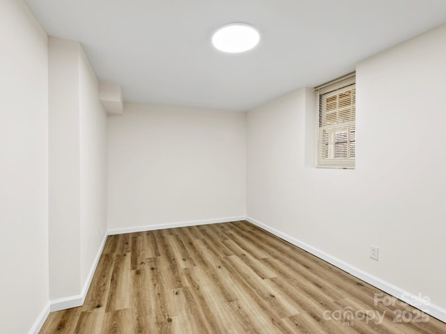 interior space with baseboards and wood finished floors