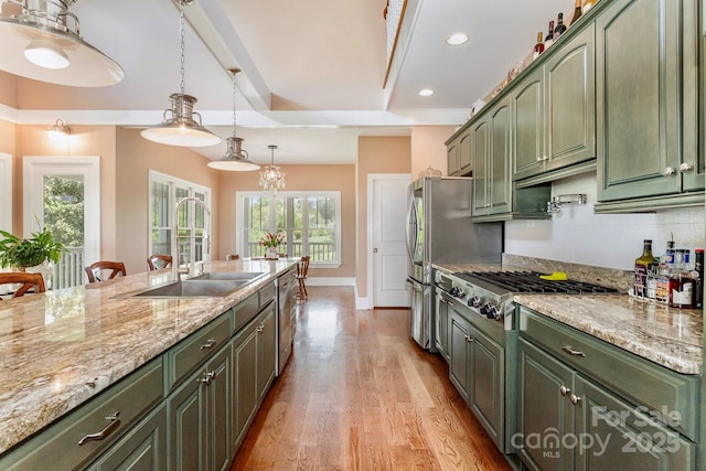 1151 Trull Hinson Rd, Wingate, NC 28174 - kitchen with green cabinetry, appliances with stainless steel finishes, light stone counters, light wood-style floors, and recessed lighting