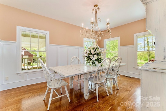 1151 Trull Hinson Rd, Wingate, NC 28174 - dining room with a decorative wall, a chandelier, a wainscoted wall, and light wood finished floors