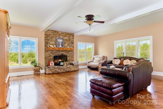 1151 Trull Hinson Rd, Wingate, NC 28174 - living room featuring beamed ceiling, ceiling fan, wood finished floors, and a fireplace