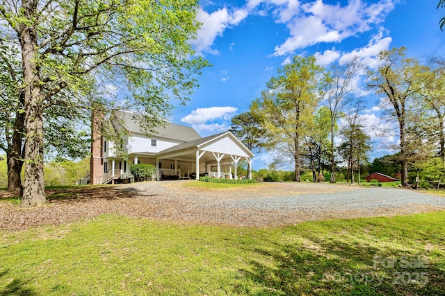 1151 Trull Hinson Rd, Wingate, NC 28174 - view of green lawn featuring gravel driveway and a carport