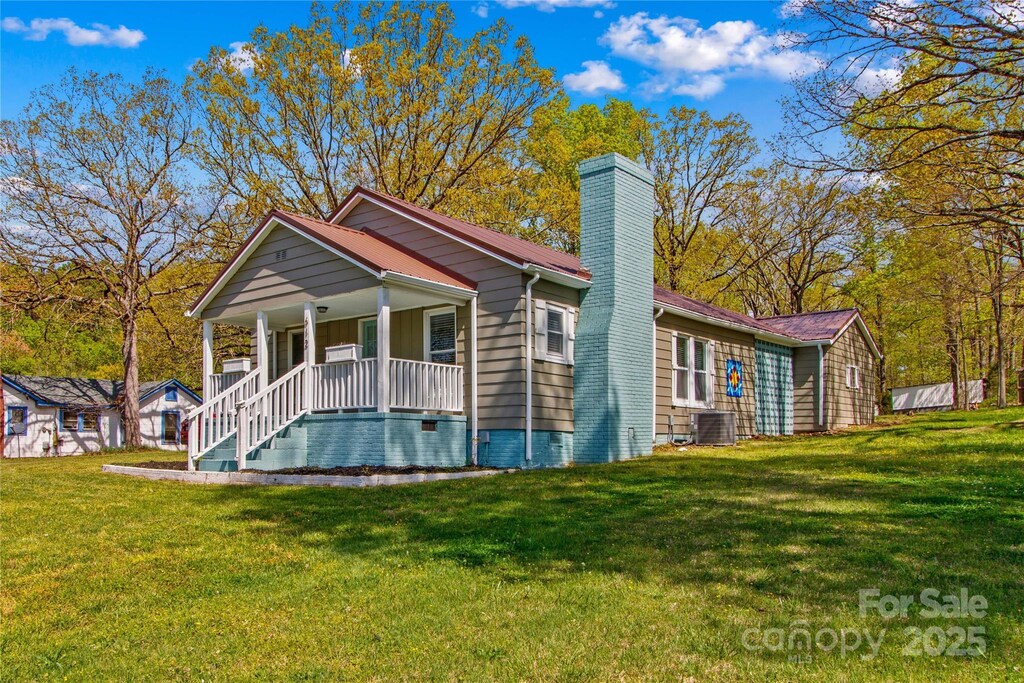 612 Rowan Mill Rd, Salisbury, NC 28147 - exterior space with a chimney, crawl space, central AC unit, a yard, and covered porch