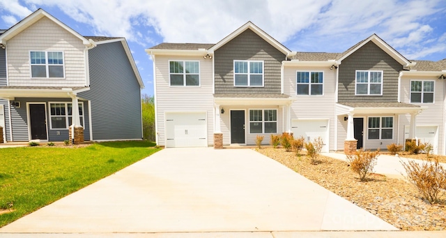 view of front of property with a garage, a front lawn, and concrete driveway