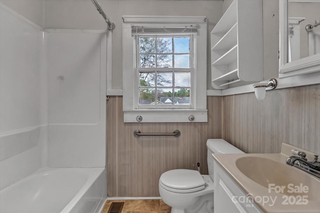 bathroom with visible vents, toilet, bathtub / shower combination, and vanity