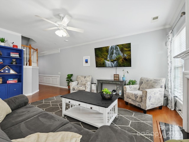living room featuring ornamental molding, ceiling fan, and wood finished floors