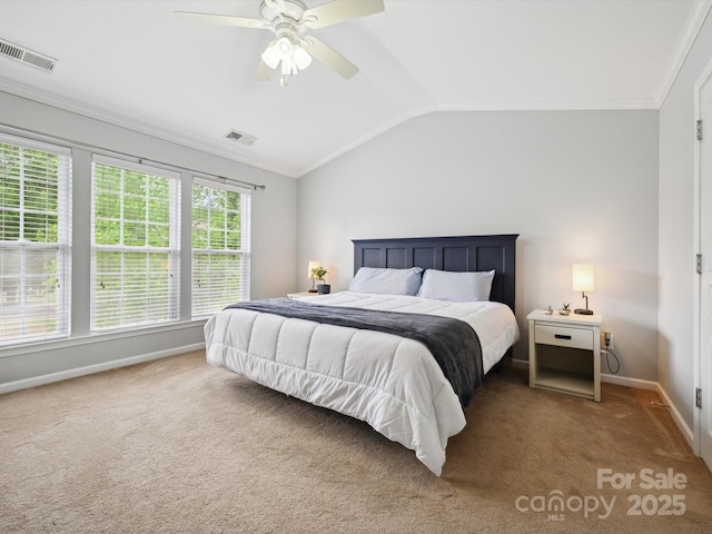 carpeted bedroom featuring baseboards, visible vents, ornamental molding, and lofted ceiling