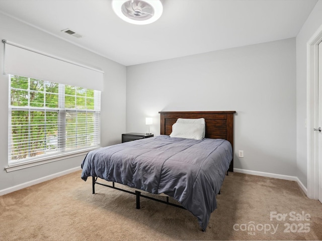 carpeted bedroom featuring visible vents and baseboards