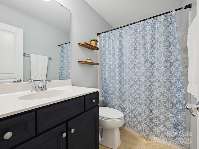 bathroom with curtained shower, vanity, toilet, and tile patterned flooring