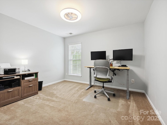 home office with visible vents, light colored carpet, and baseboards