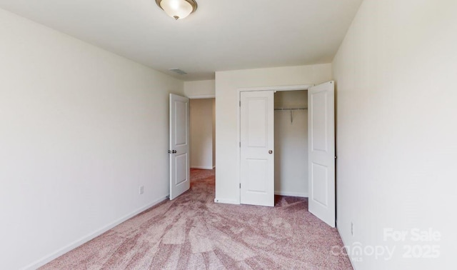 unfurnished bedroom featuring carpet flooring, a closet, and baseboards