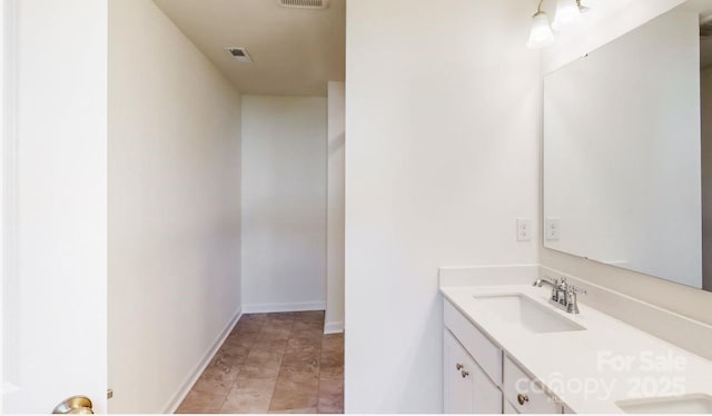 bathroom with vanity, baseboards, and visible vents