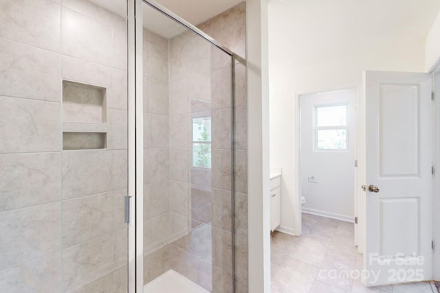 bathroom with a shower stall, vanity, and toilet
