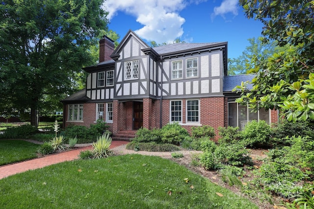 801 Berkeley Ave, Charlotte, NC 28203 - tudor house with a chimney, brick siding, stucco siding, and a front yard