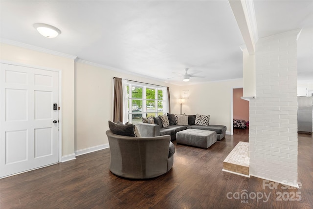 living area with decorative columns, ornamental molding, dark wood-type flooring, and a ceiling fan