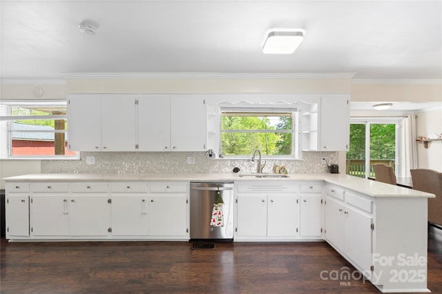 kitchen with open shelves, light countertops, dishwasher, a sink, and a peninsula