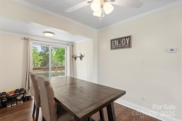 dining space featuring ornamental molding, baseboards, a ceiling fan, and dark wood-type flooring